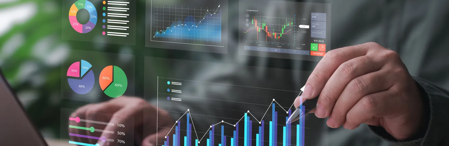 Businessman pointing at performance metrics while using his laptop.