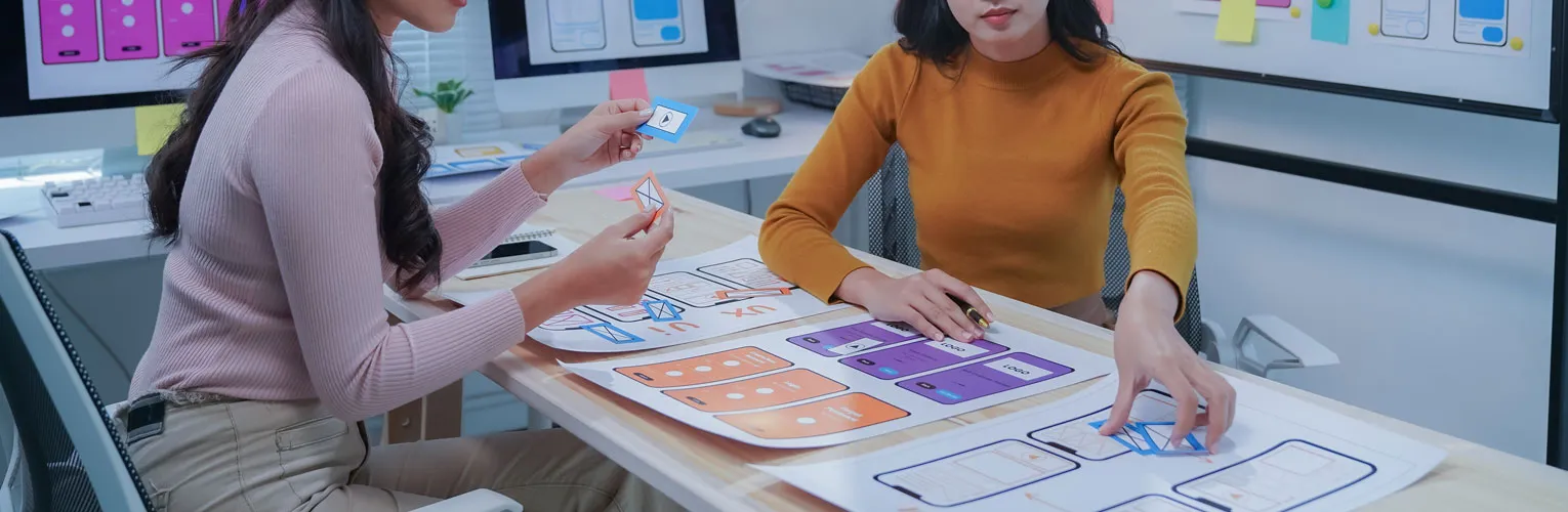 UI/UX designers working together on a website’s landing page.