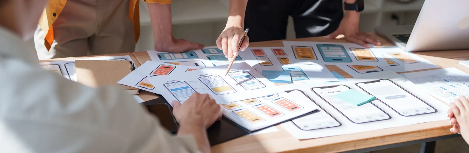 Creative professionals discussing wireframes and user experience designs