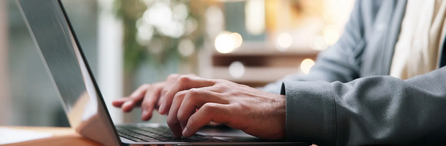 Man typing on a laptop